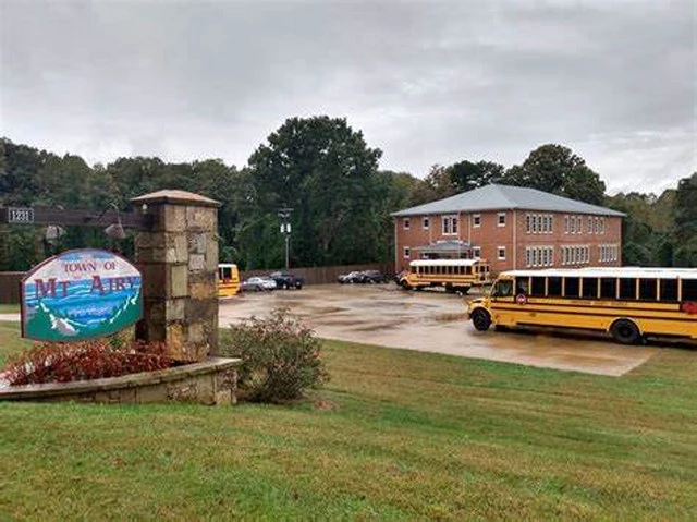 picture of the welcom to Mt. Airy sign and the old schoolhouse in Mt. Airy, ga.